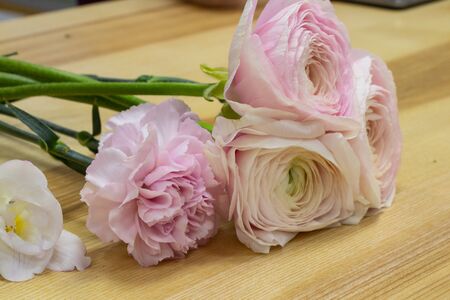 a bouquet of eustoma flowers lies on a tableの写真素材