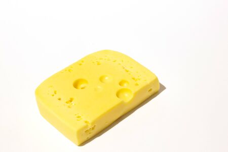 piece of cheese on a white isolated backgroundの写真素材