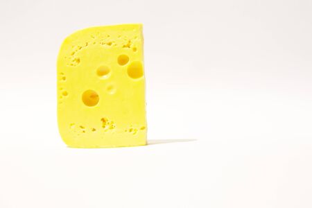 piece of cheese on a white isolated backgroundの写真素材