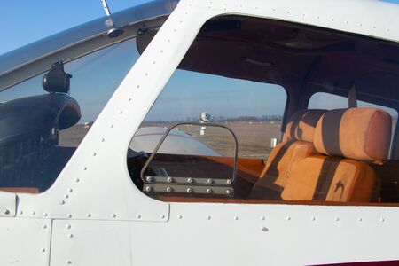 small old plane stands at the airport in the city of Dnieper on a sunny dayの写真素材