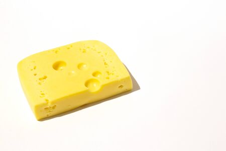 piece of cheese on a white isolated backgroundの写真素材