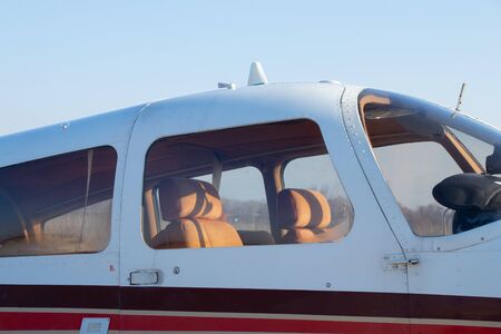 small old plane stands at the airport in the city of Dnieper on a sunny dayの写真素材
