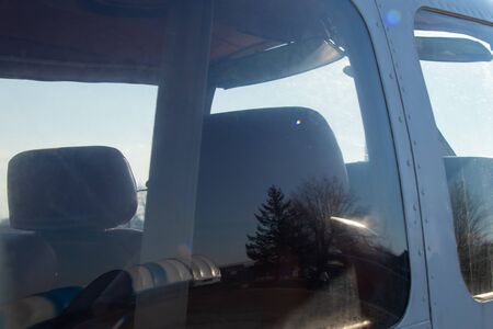 small old plane stands at the airport in the city of Dnieper on a sunny dayの写真素材