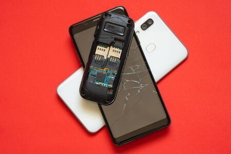 several broken broken phones on from