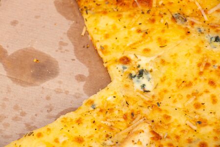 four cheese pizza in a box close-up on a picnicの写真素材