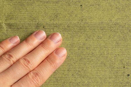 female hands of a young girl lie on an isolated background close-upの写真素材