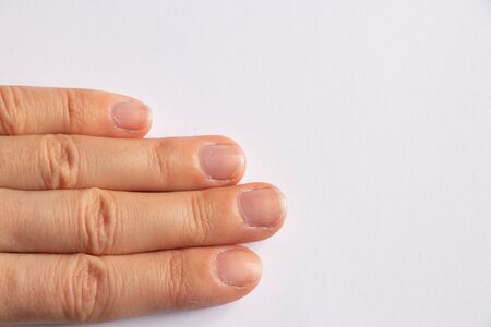 female hands of a young girl on a white background close-upの写真素材