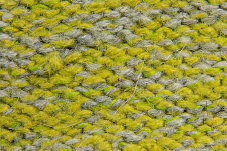 light green background of knitted fabric sweaters closeupの写真素材