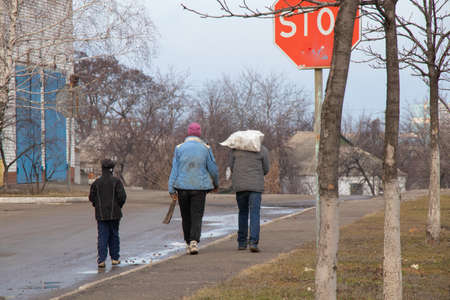 Ukraine, Dnipro - May 30, 2020. A family of beggars collecting garbage on the street travels along the road in the spring to Ukraine to the cities of the Dnieper, unemployment in quarantineのeditorial素材