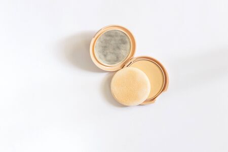 face powder with a mirror on a white background top view of makeupの写真素材