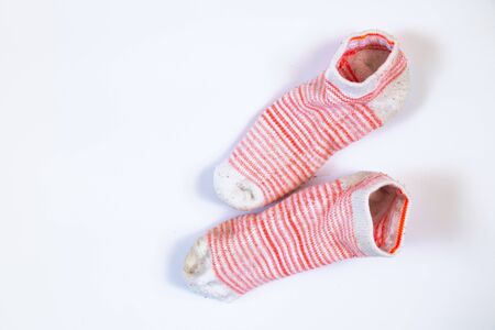 dirty white striped women's socks on a white backgroundの写真素材