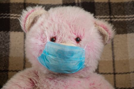 baby teddy bear masked medical closeup epidemicの写真素材