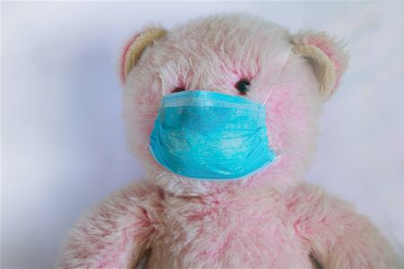 baby teddy bear masked medical closeup epidemicの写真素材