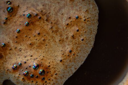 coffee foam in a cup of black coffee macroの写真素材
