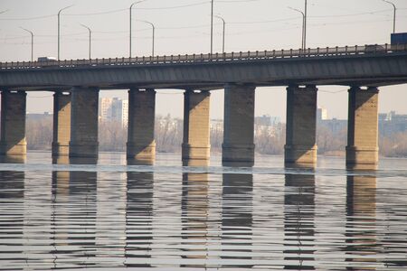 old kaydak bridge across the Dnieper river in the morning in springの写真素材