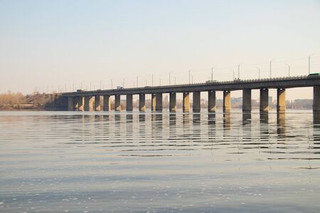 old kaydak bridge across the Dnieper river in the morning in springの写真素材