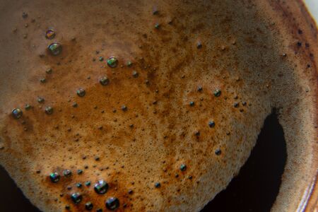 coffee foam in a cup of black coffee macroの写真素材