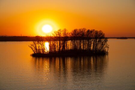 sunset on the banks of the Dnieper river among trees in Ukraine in the Dnieper citiesの写真素材