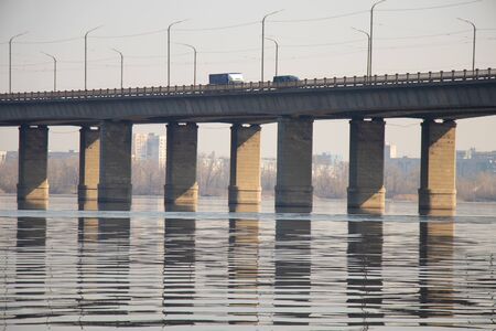 old kaydak bridge across the Dnieper river in the morning in springの写真素材
