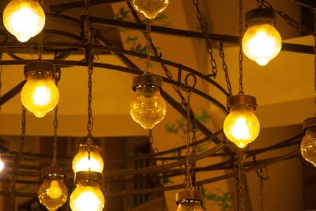 old chandelier on the wall in a dark room indoorsの写真素材