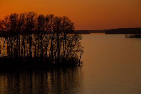 sunset on the banks of the Dnieper river among trees in Ukraine in the Dnieper citiesの写真素材