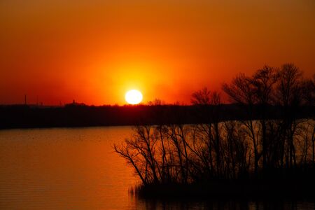 sunset on the banks of the Dnieper river among trees in Ukraine in the Dnieper citiesの写真素材
