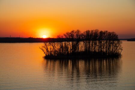 sunset on the banks of the Dnieper river among trees in Ukraine in the Dnieper citiesの写真素材