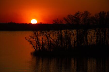sunset on the banks of the Dnieper river among trees in Ukraine in the Dnieper citiesの写真素材