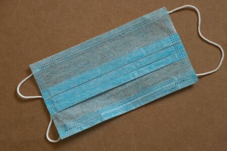 medical mask on brown paper background close-upの写真素材