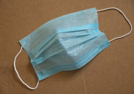 medical mask on brown paper background close-upの写真素材