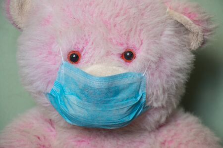 baby teddy bear masked medical closeup epidemicの写真素材