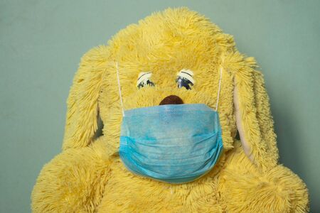baby teddy bear masked medical closeup epidemicの写真素材