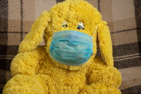 baby teddy bear masked medical closeup epidemicの写真素材
