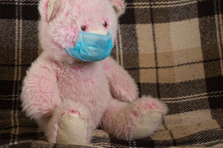 baby teddy bear masked medical closeup epidemicの写真素材