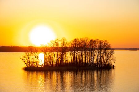 sunset on the banks of the Dnieper river among trees in Ukraine in the Dnieper citiesの写真素材