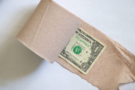 one american dollar roll up toilet paper roll on white backgroundの写真素材