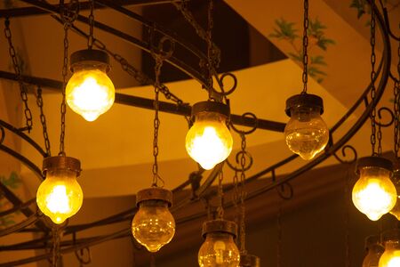old chandelier on the wall in a dark room indoorsの写真素材