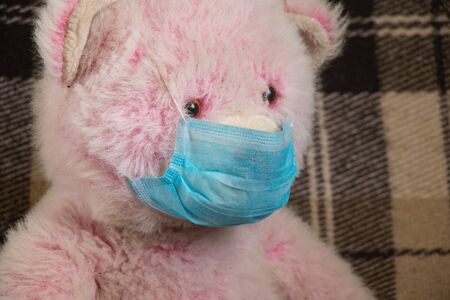 baby teddy bear masked medical closeup epidemicの写真素材