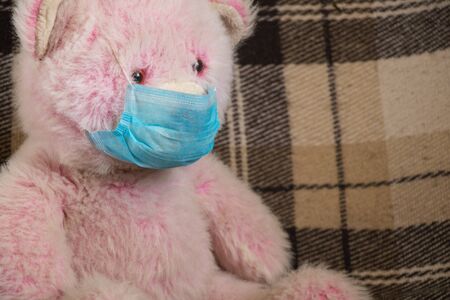baby teddy bear masked medical closeup epidemicの写真素材