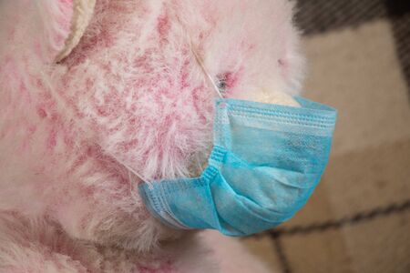 baby teddy bear masked medical closeup epidemicの写真素材