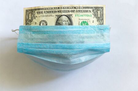 medical mask lies on one dollar on a whiteの写真素材