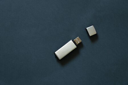 USB drive lies on a dark background