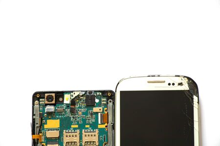 broken phone and disassembled phone nearby