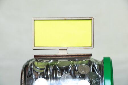 tv stands on cans with ukrainian kopecks on an isolated background, place for textの写真素材