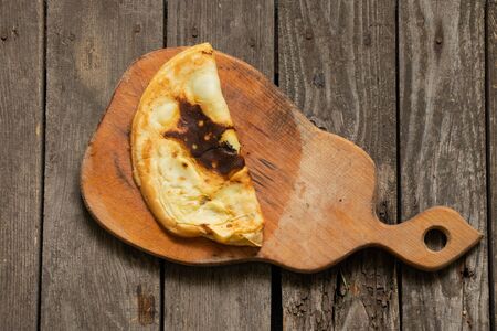 burnt fried pancakes on a blackboard on a table in the kitchenの写真素材