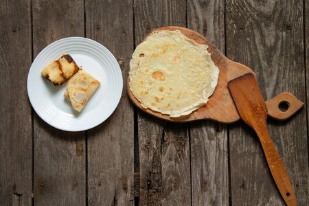 fried pancakes on a blackboard on a table in the kitchenの写真素材