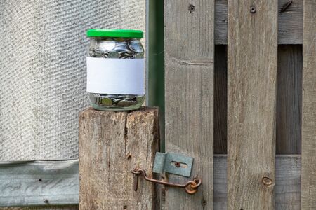 jar with Ukrainian coins and a white label with place for text standsの写真素材