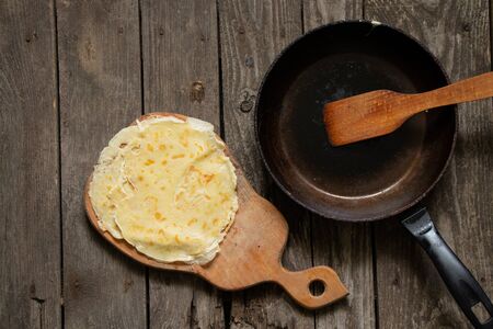 fried pancakes on a blackboard on a table in the kitchenの写真素材