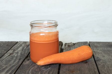 freshly squeezed carrot juice in a glass jarの写真素材
