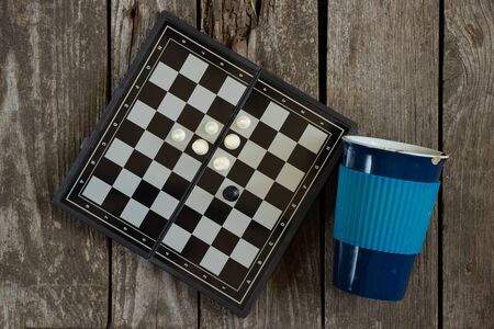 chess board and cup on a wooden table quarantined leisure